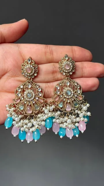 ESMÉ mint and blush kundan chandbalis held in a palm